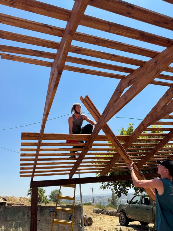 Guys building pergola frame